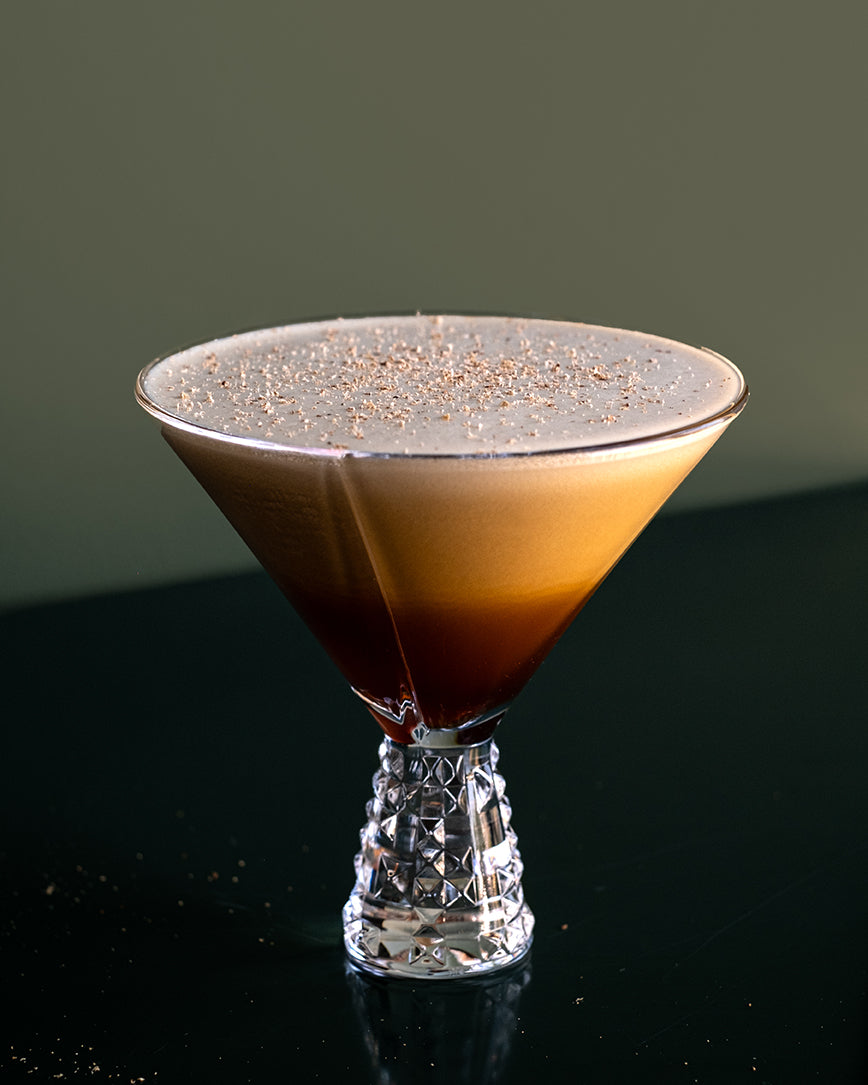 an espresso martini in a crystal martini glass