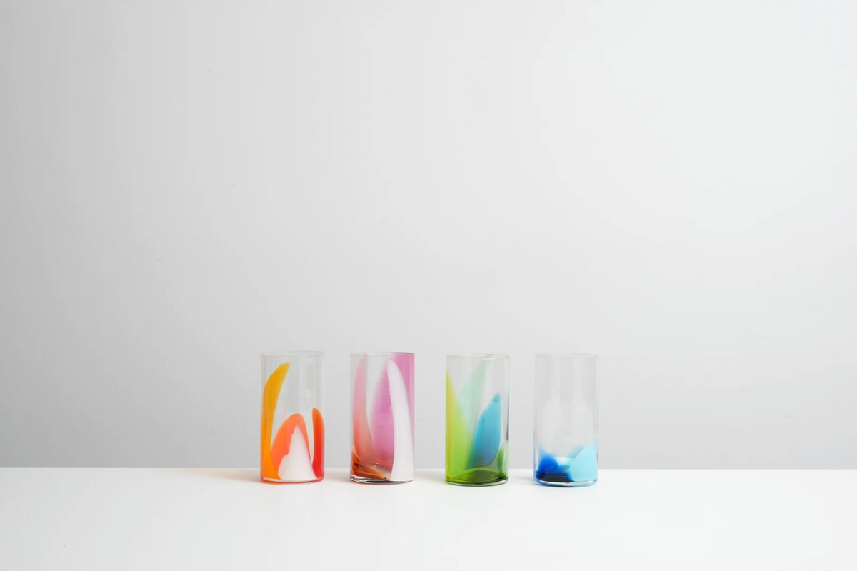 a line of colourful hand blown tumblers